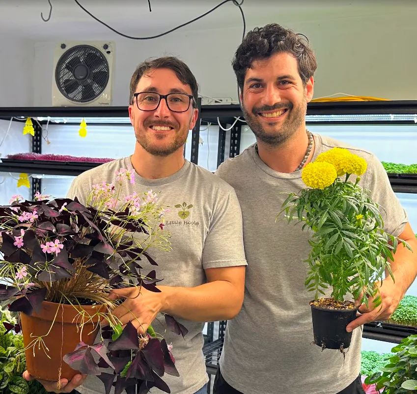 Amery and Jonah Krochmalnek holding plants at Little Roots Farm